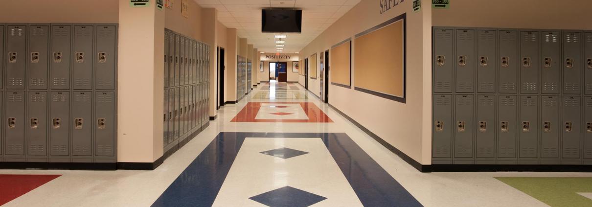 Charter school construction. Wide school hallway with bulletin boards and lockers