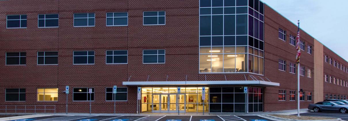 Education construction. School building exterior of brick and glass