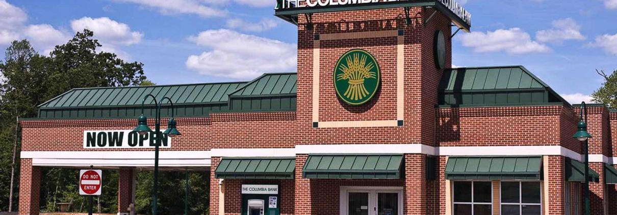 Bank building construction featuring brick exterior with drive-thru