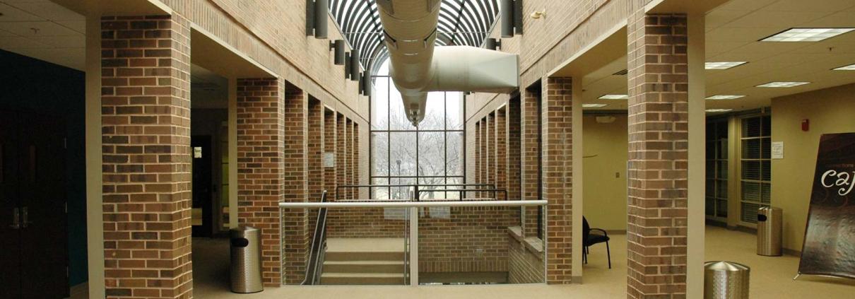 Hallway with curved skylight and large window for sanctuary renovation project