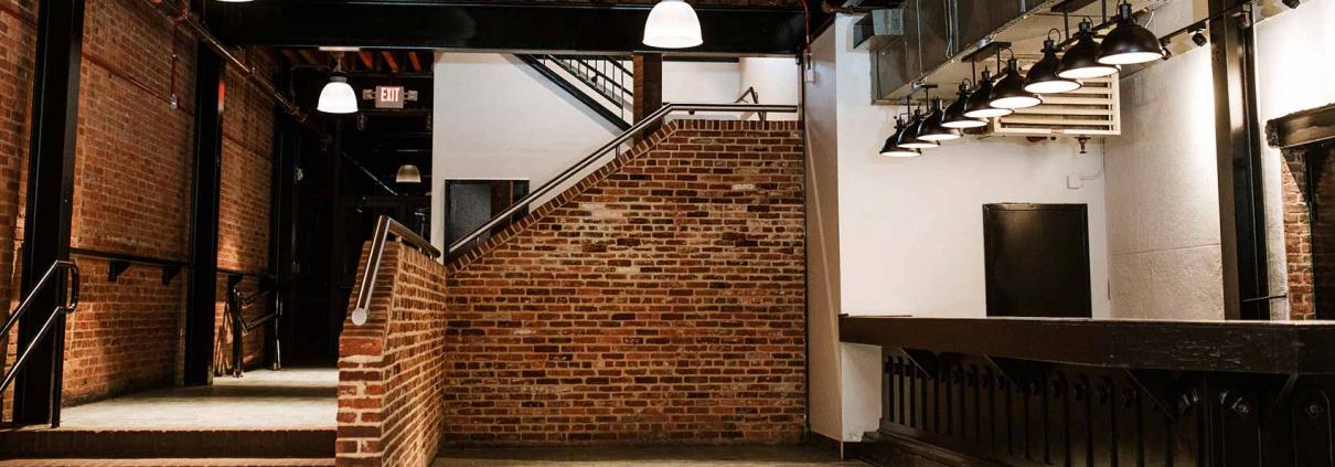 Brick event space interior with beam ceiling renovated by KasCon commercial general contractors