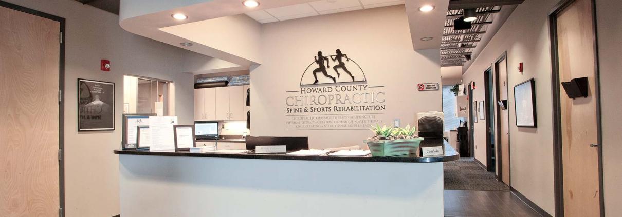 Close-up of reception desk with Howard County Chiropractic custom signage